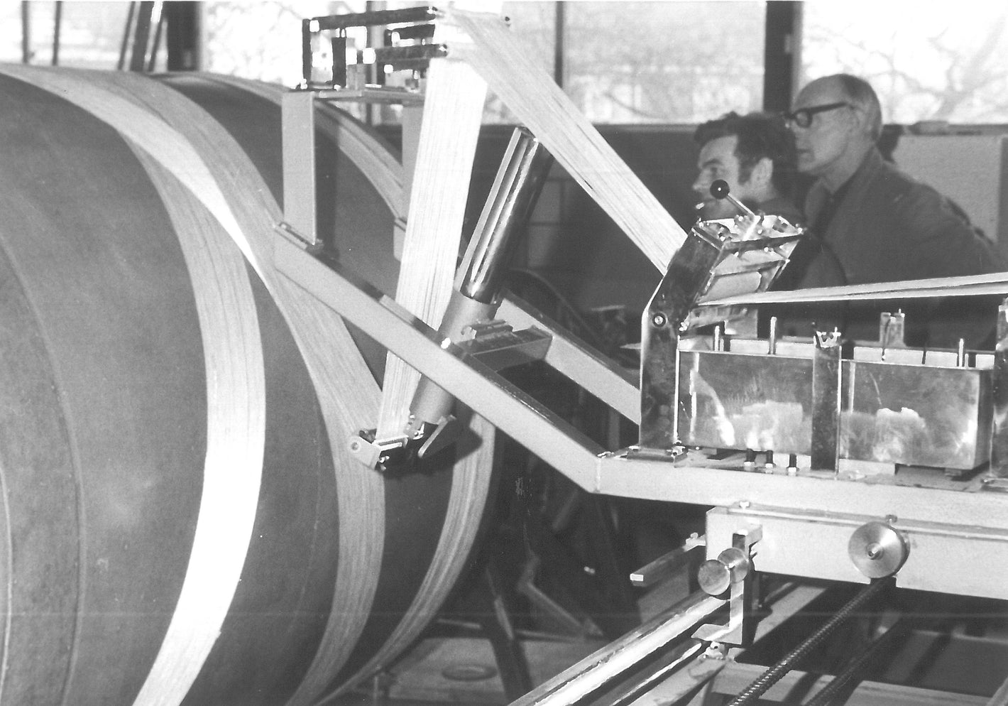 A black and white photo of filament winding when the technology was quite new