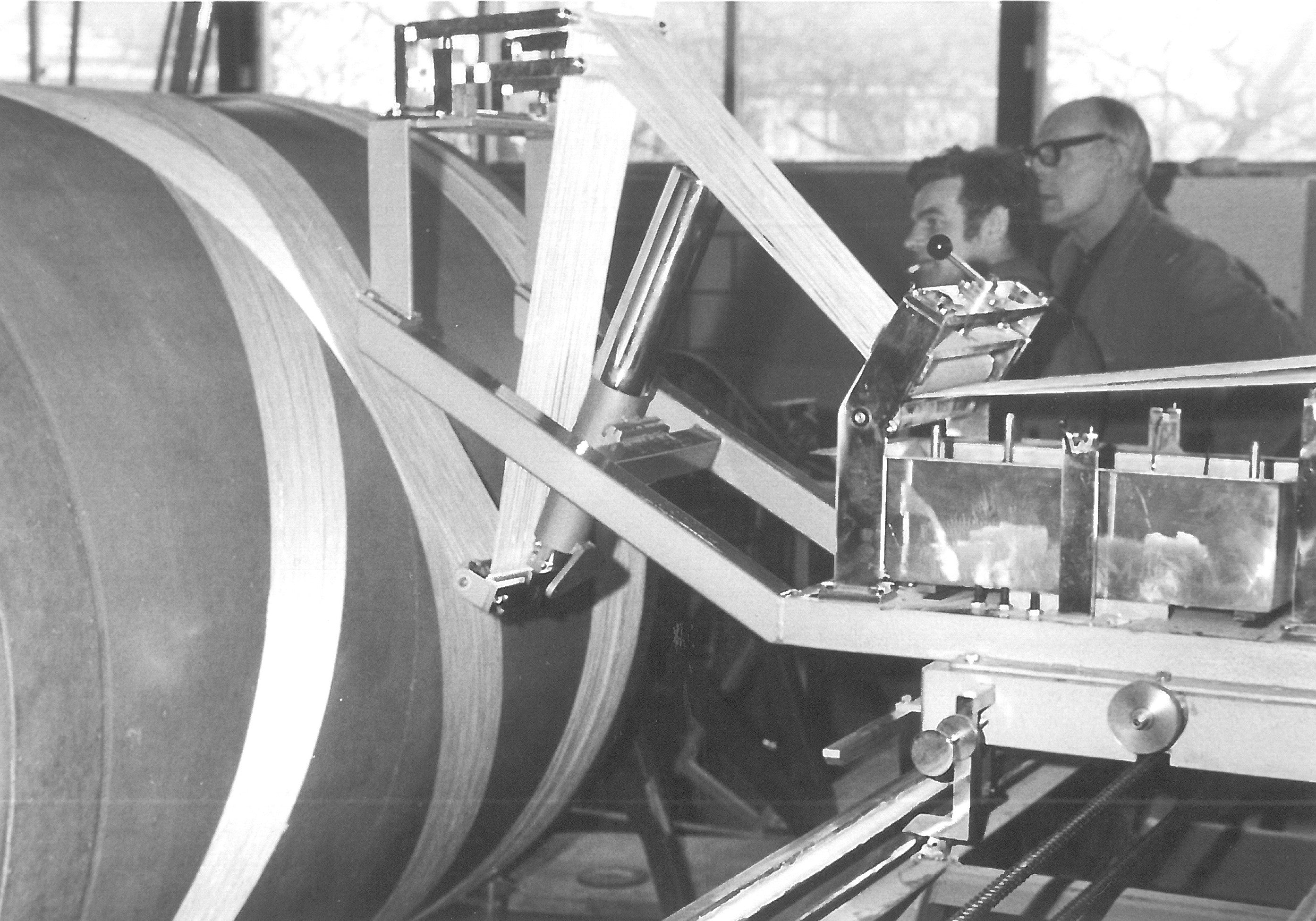 A black and white photo of filament winding when the technology was quite new