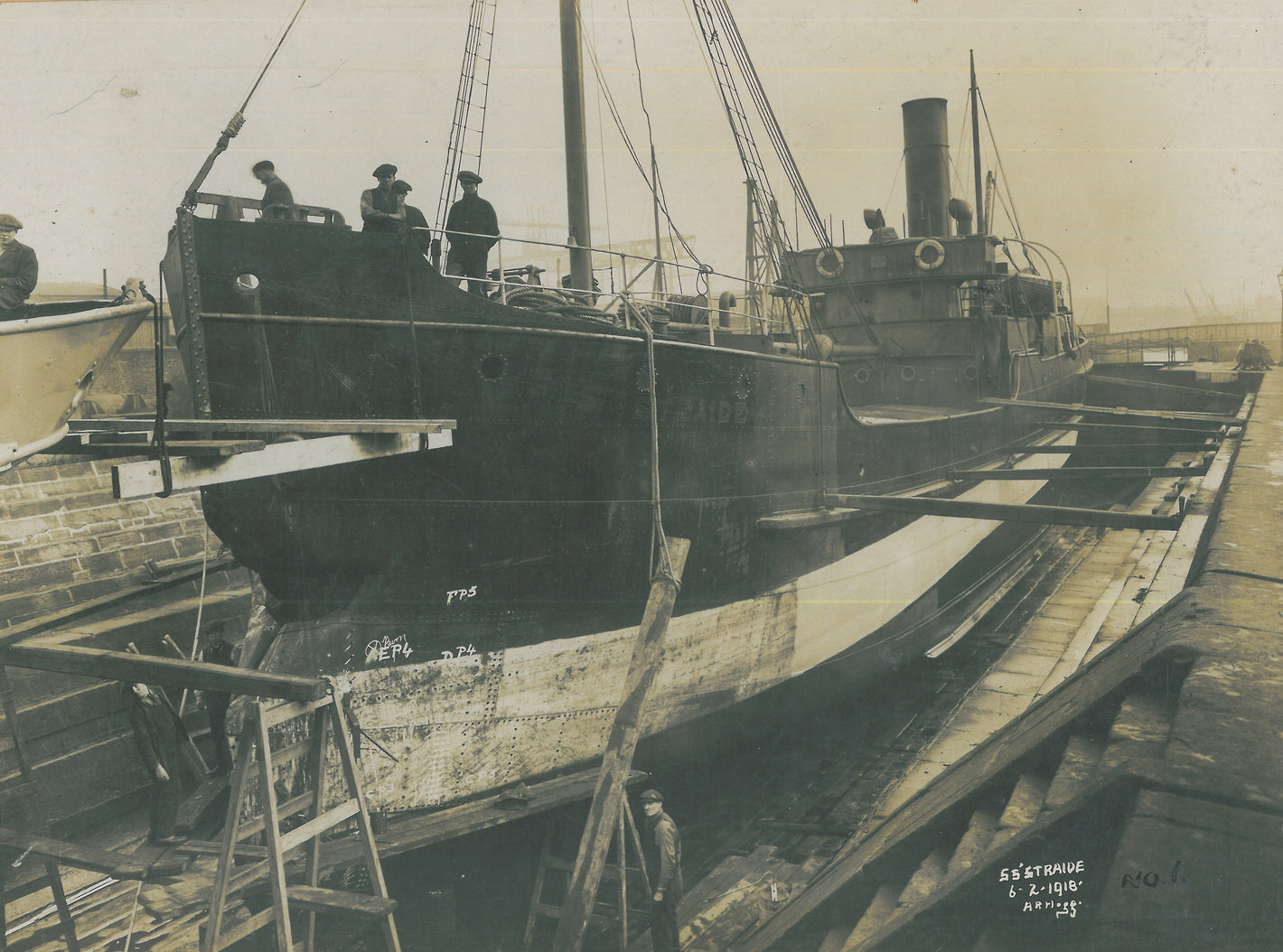 The SS Straide is repaired after suffering damages from a german mine. Photo shows date as 1918 Belfast docks.