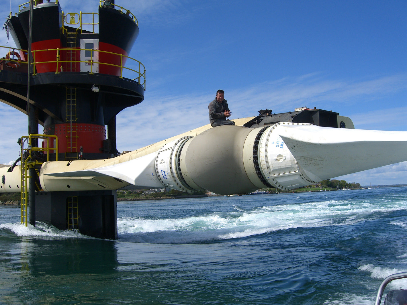 A CCP Gransden employee is strapped-in above the Seagen tidal generator in Strangford Lough
