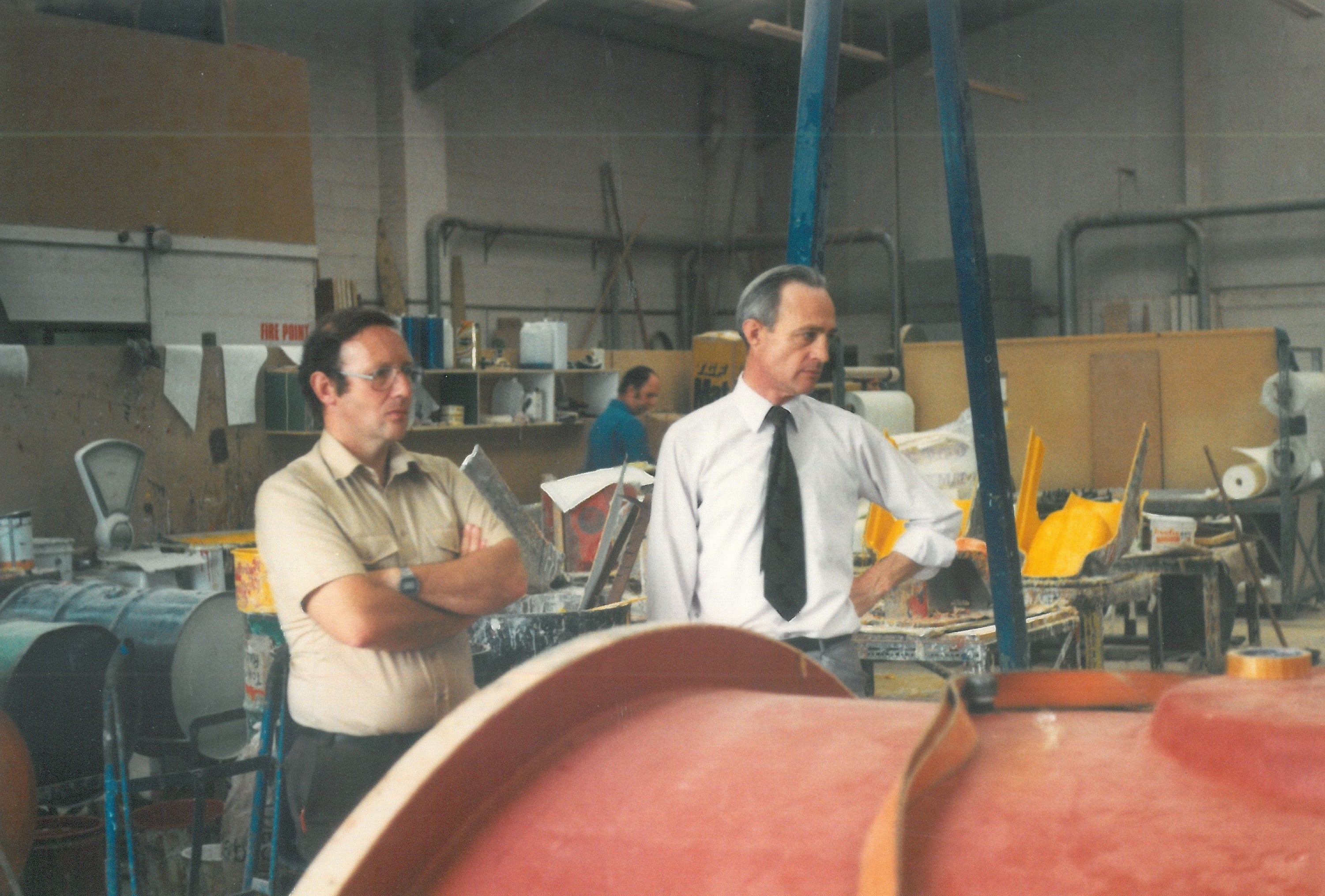 Two engineers stand in the CCP Gransden shopfloor in the 1980's assessing some GRP works.