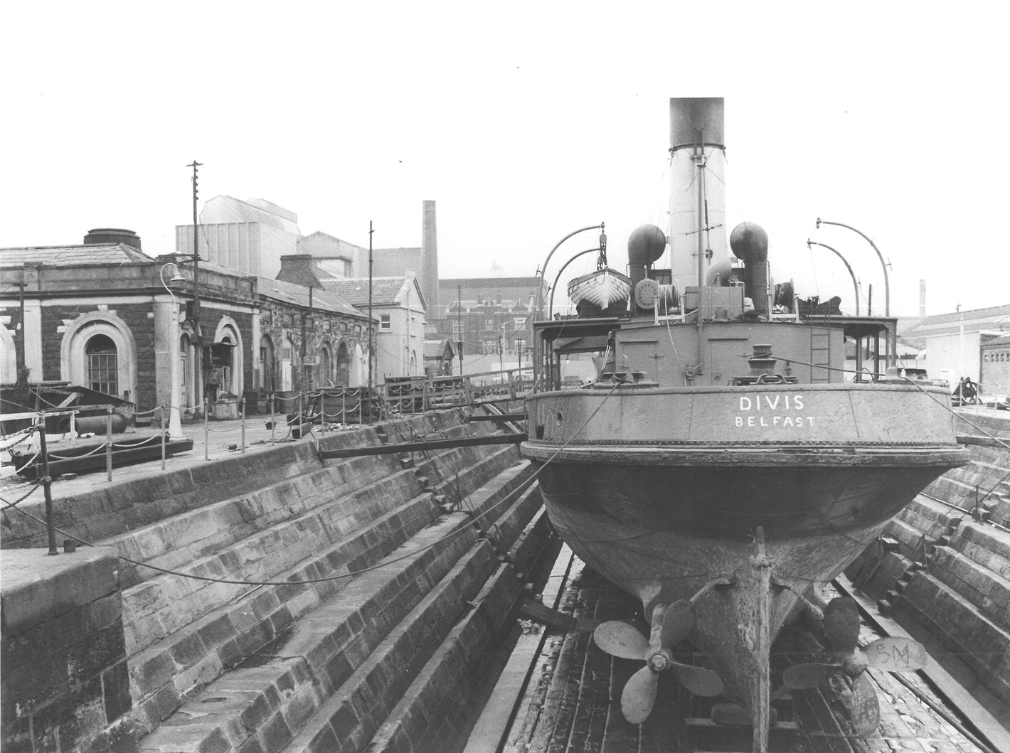 A ship called the Divis sits in dock undergoing repairs